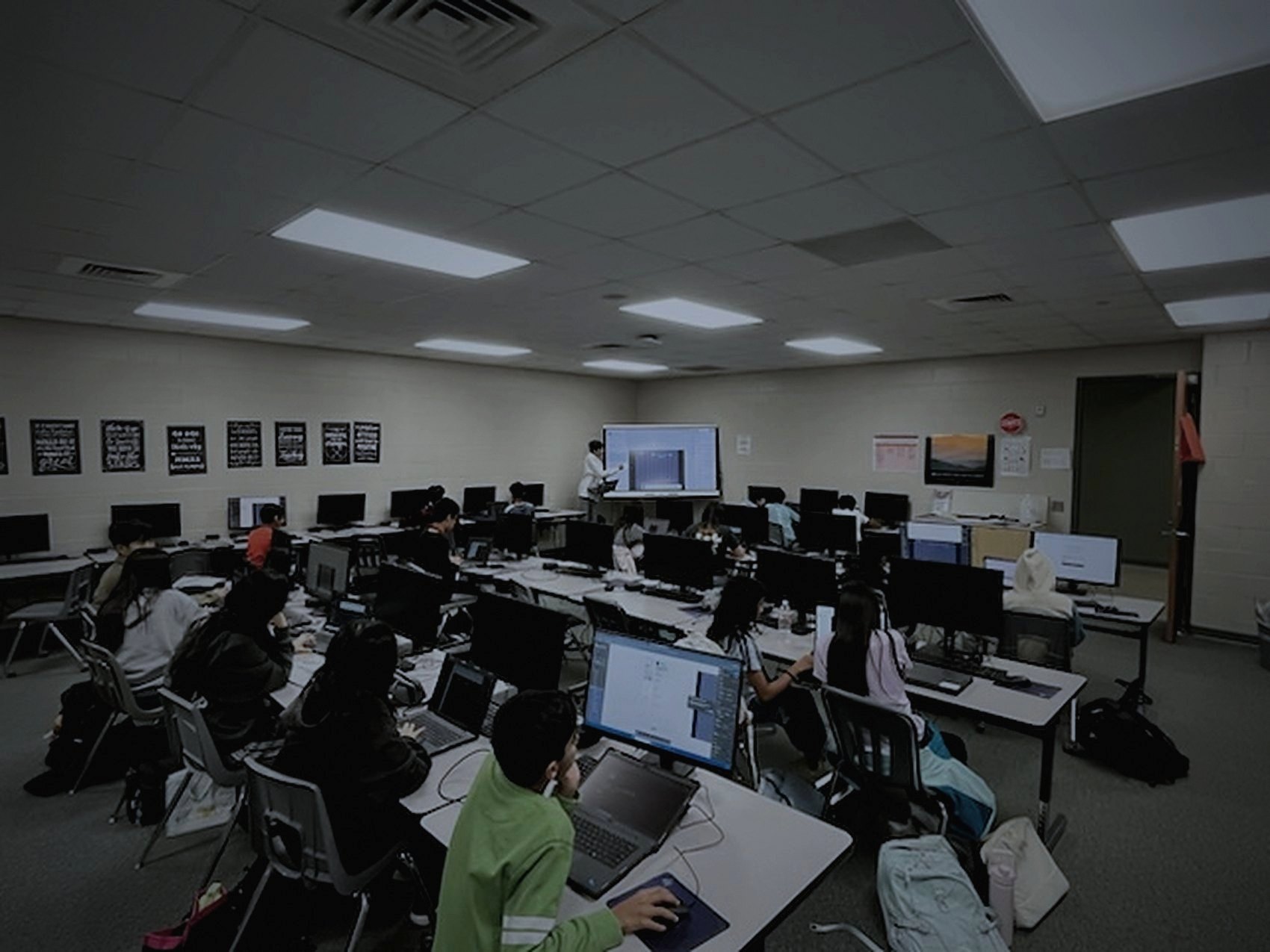 A full computer lab of students working during a Digital Design Club meeting